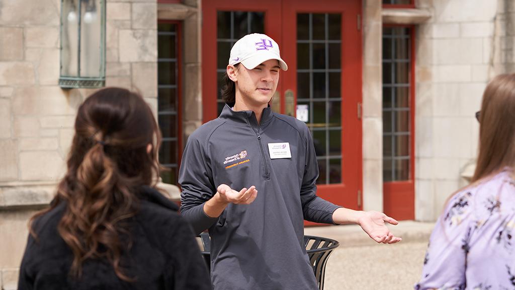 Student leading a tour outside